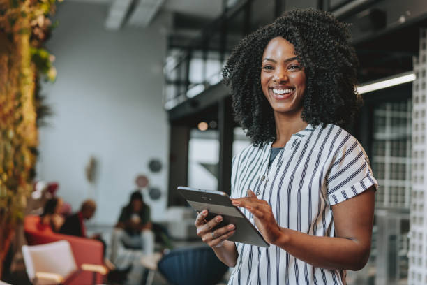 Business woman holding digital tablet smiling